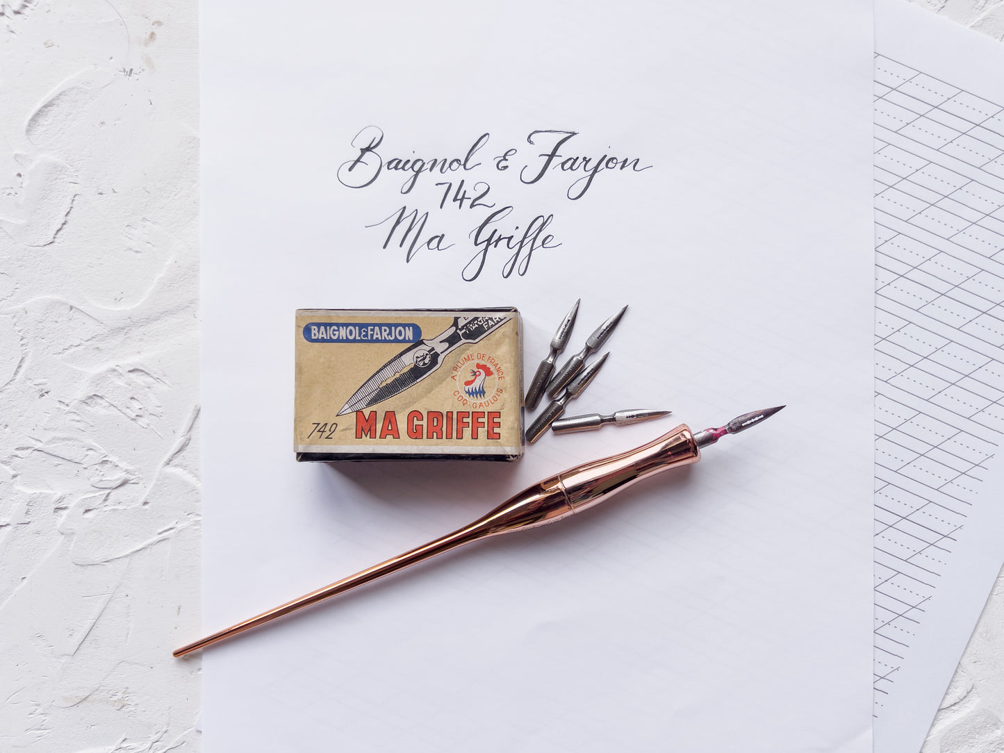 Ink pen and ink bottle with 'Braigol & Farjon' packaging on a textured white surface.