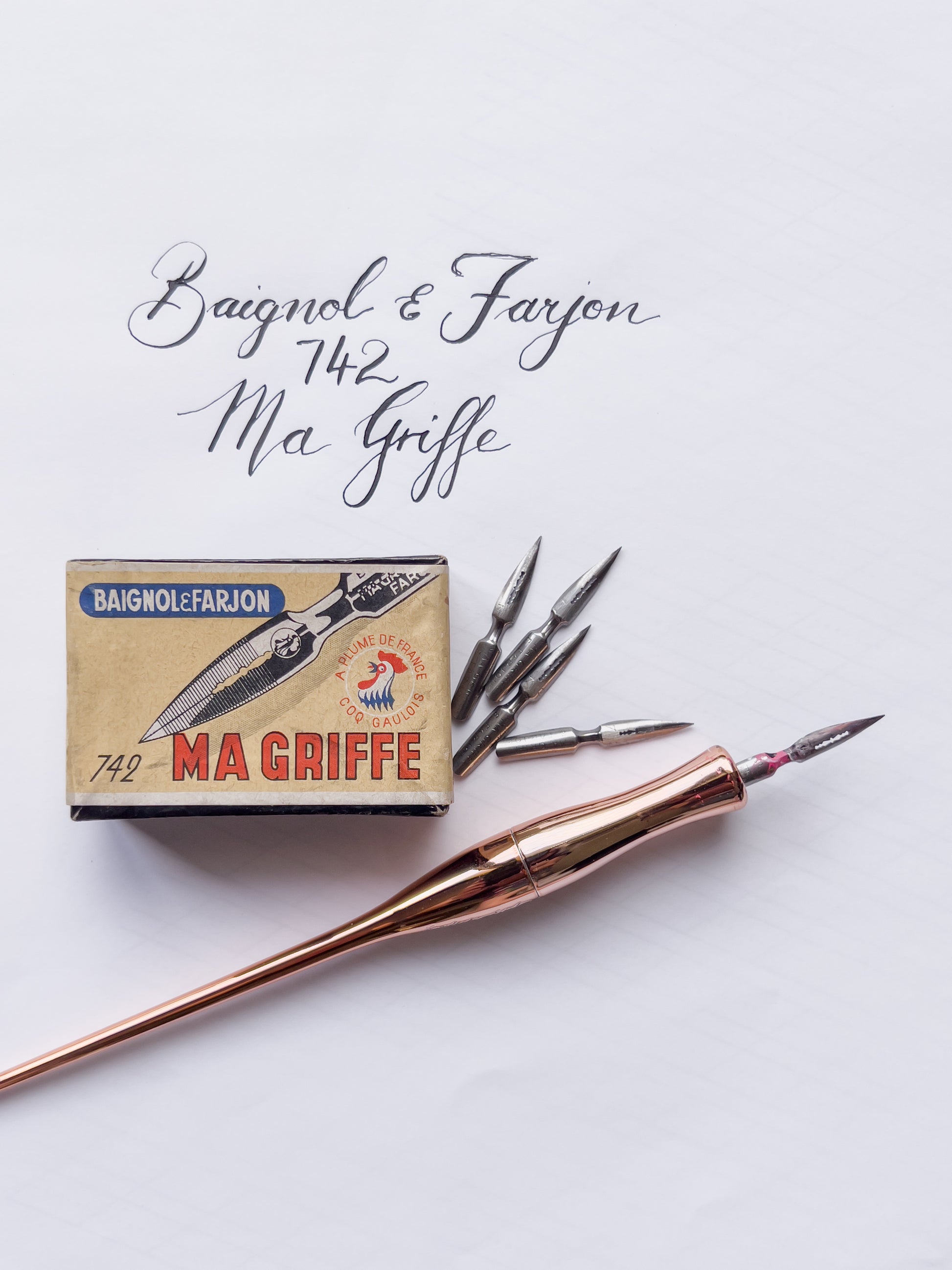 Rose gold pen with 'Ma Griffe' packaging on a light gray background