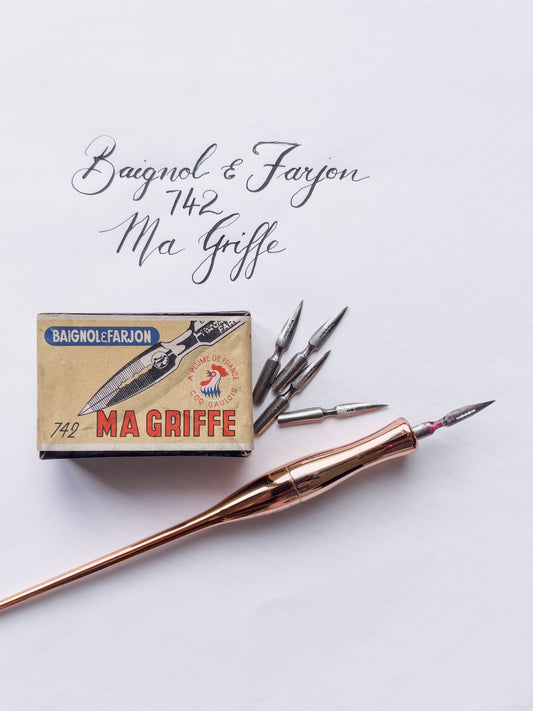 Rose gold pen with 'Ma Griffe' packaging on a light gray background