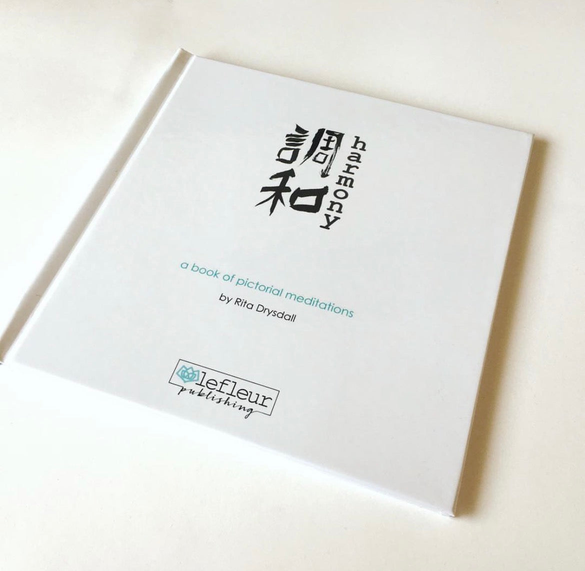 White book titled 'Harmony' with Japanese characters on a white background